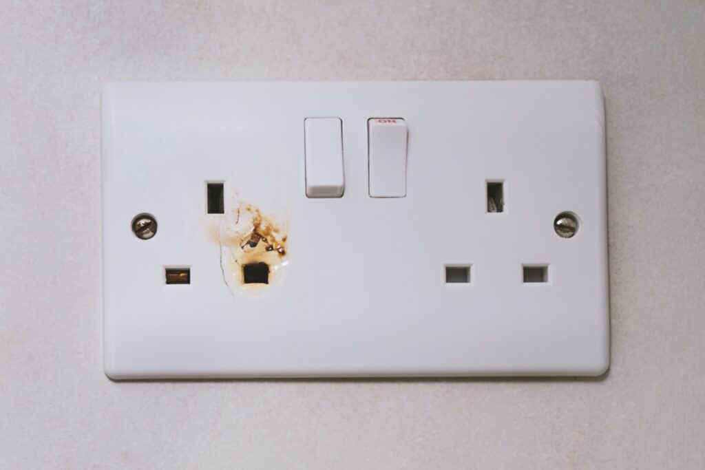 Broken power overload switch electric outlet