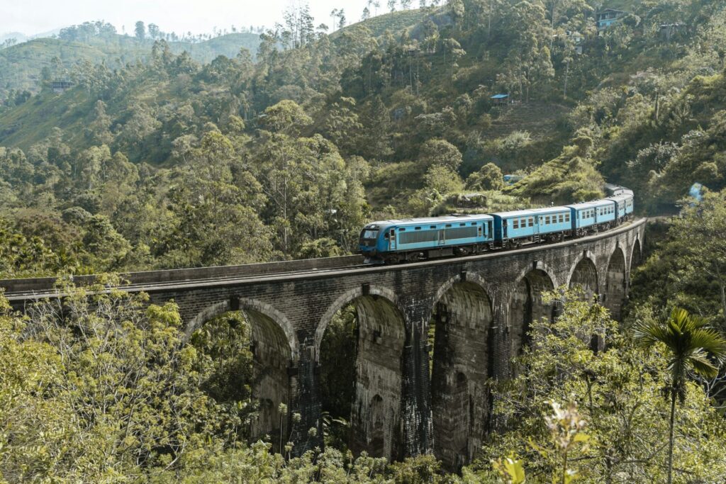 Beautiful shot of a blue train on the Nine Arch Bridge in Sri Lanka