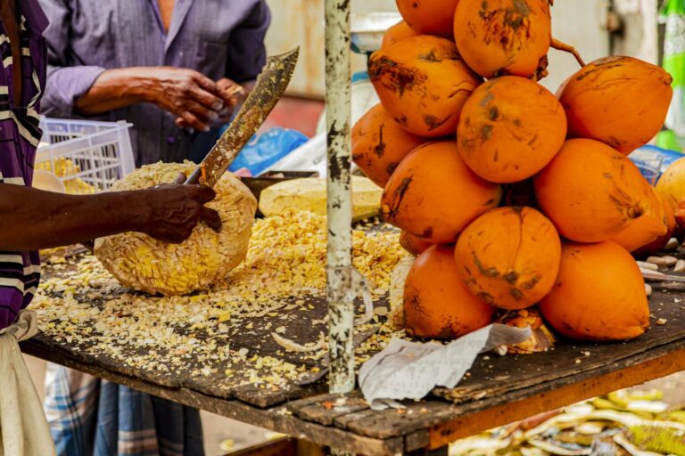 Preparing of a coconut for drinking on a Colombo market at Sri Lanka