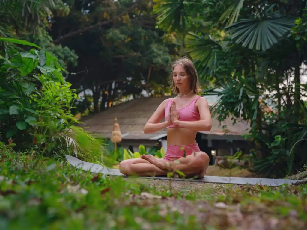 Beautiful woman practices yoga in Crabi, Thailand