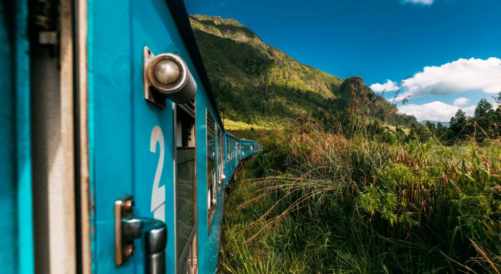 Blue Sri Lankan Train goes through jungles, trees, wood, mountains. Famous blue train in Sri Lanka